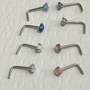 Eight stainless steel L-shaped nose rings. Brand new